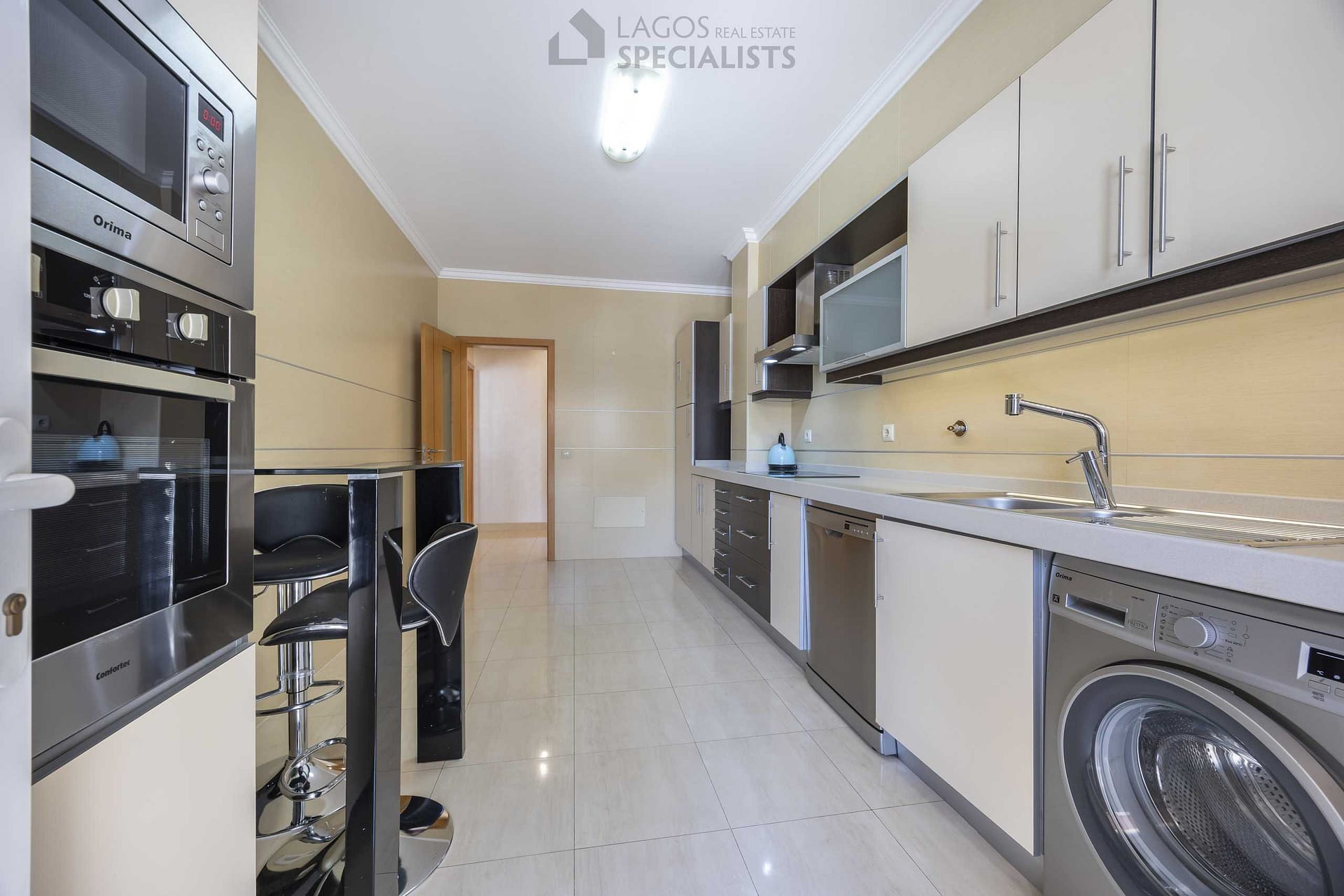 Fully equipped kitchen with modern appliances and terrace access