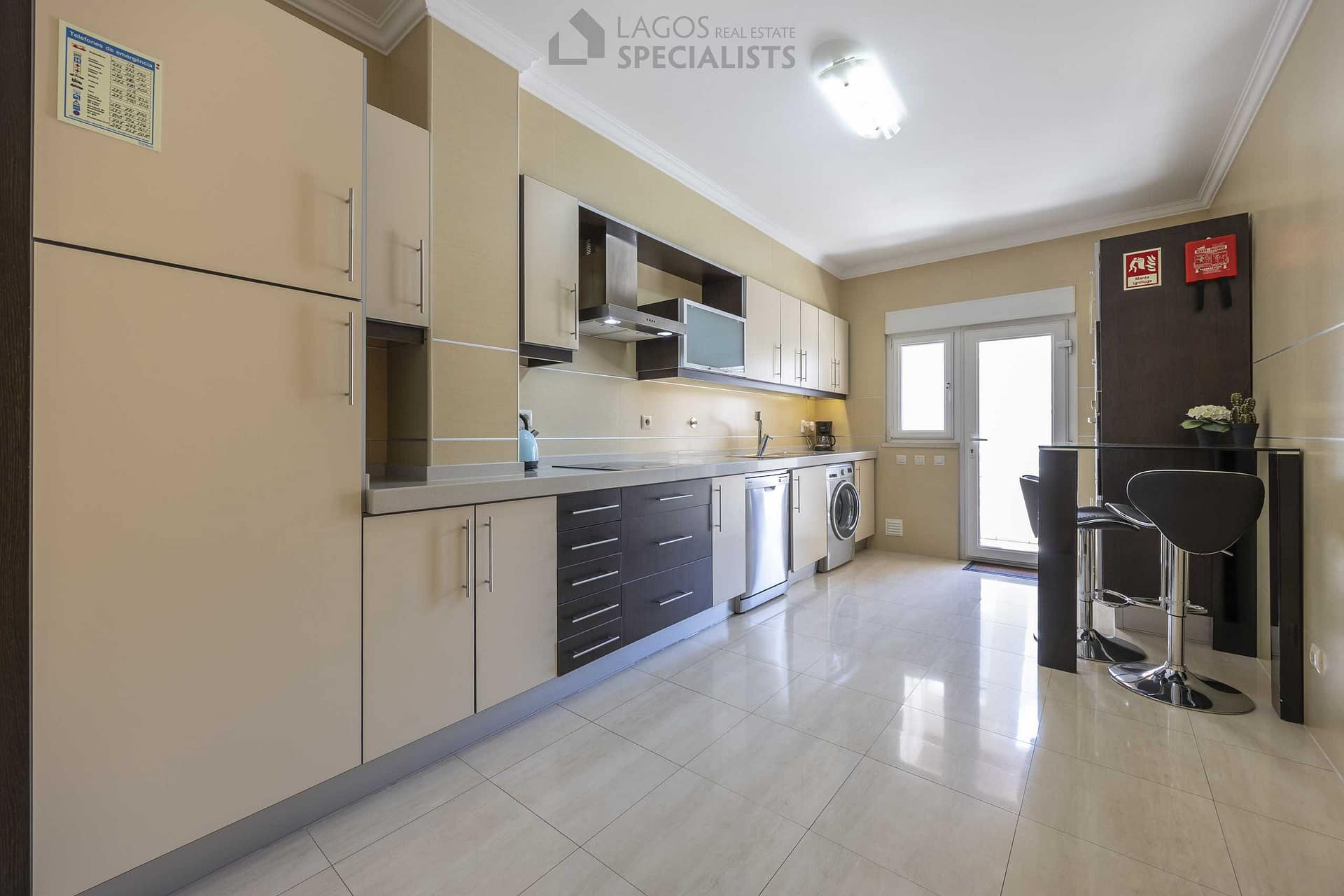 Fully equipped kitchen with modern appliances and terrace access