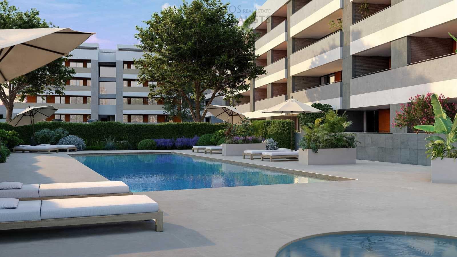 Communal swimming pool surrounded by sun loungers, umbrellas, and gardens at the Domus apartments in Lagos.