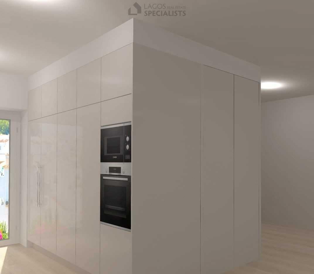 Sleek kitchen cabinets and integrated appliances in new Algarve home