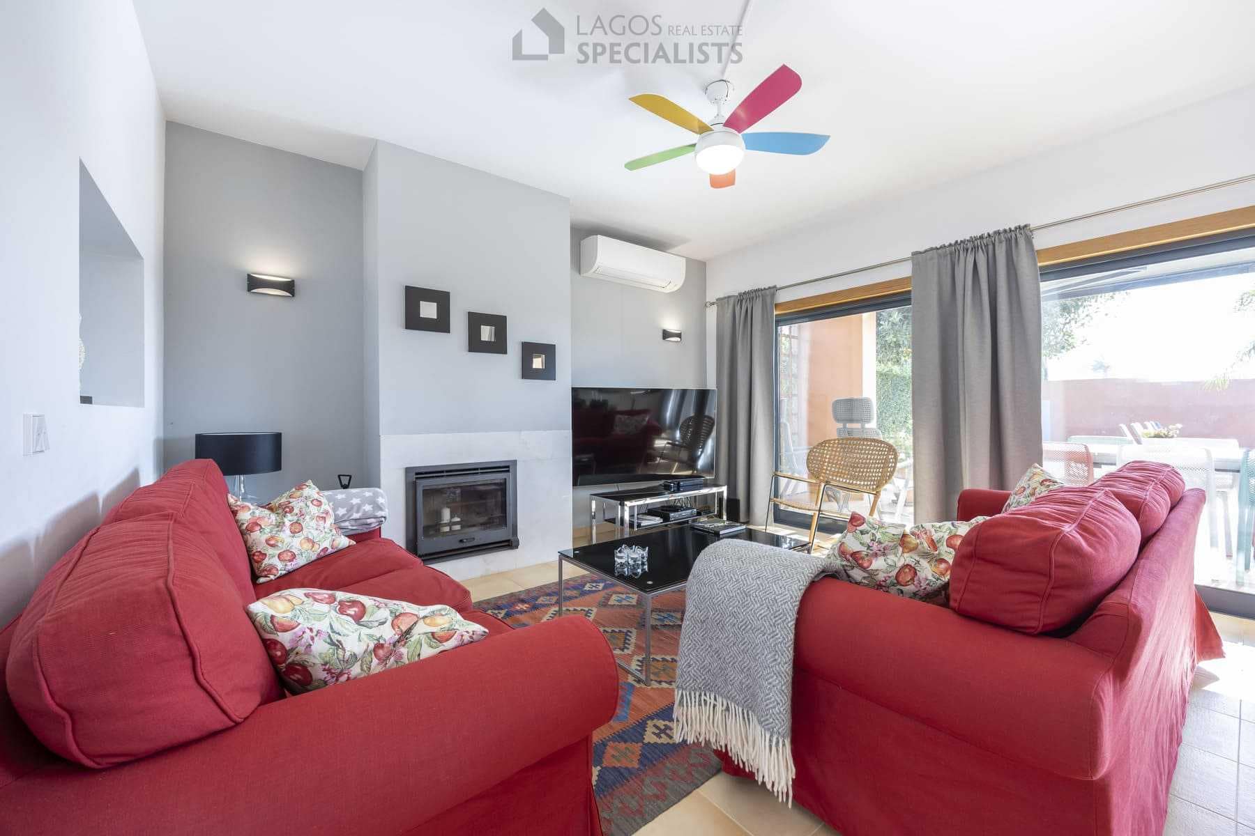 Living room with red sofas and fireplace, modern villa in Lagos