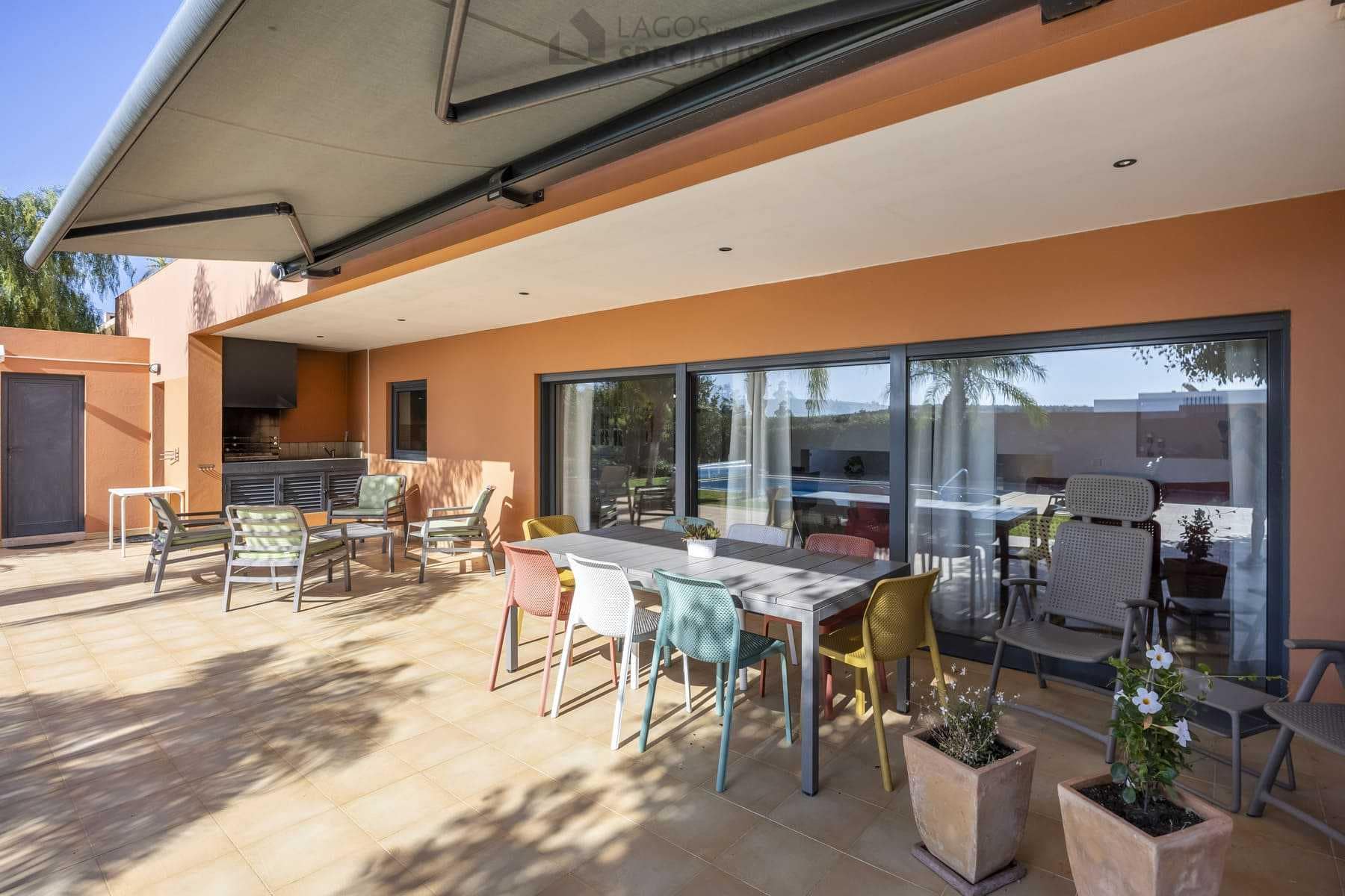 Outdoor dining space and seating area by pool, modern villa in Lagos