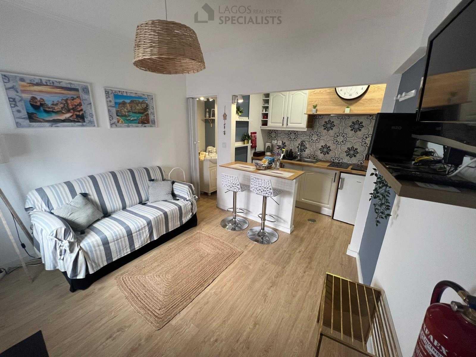 Cozy living area with sofa, TV and bar counter – house for sale in Lagos historic centre